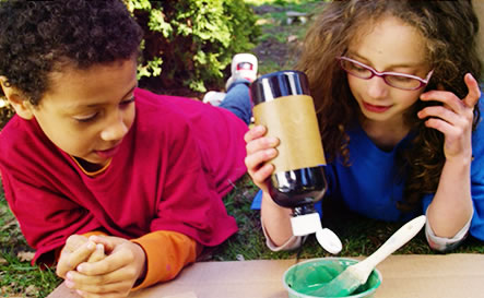 A boy and girl pouring paint.